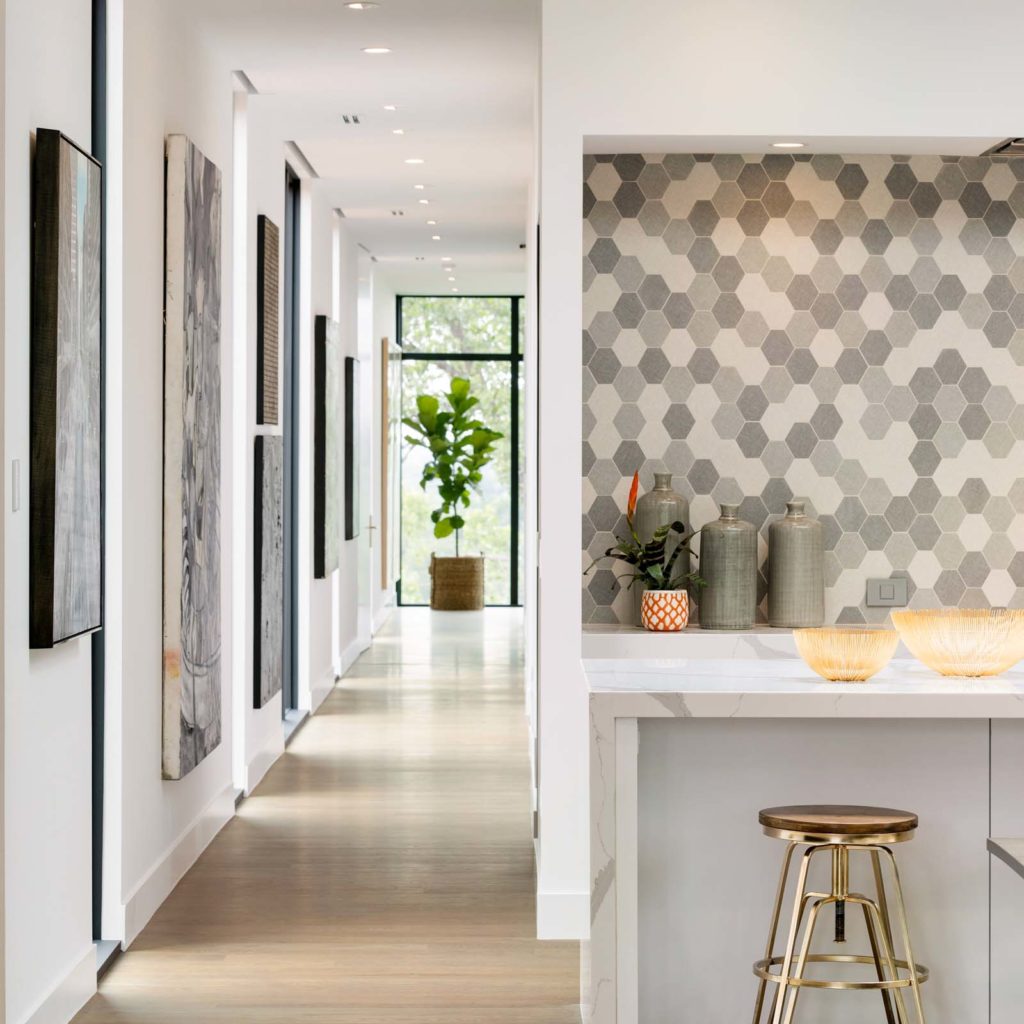 A modern home with a grey tile backsplash in the kitchen
