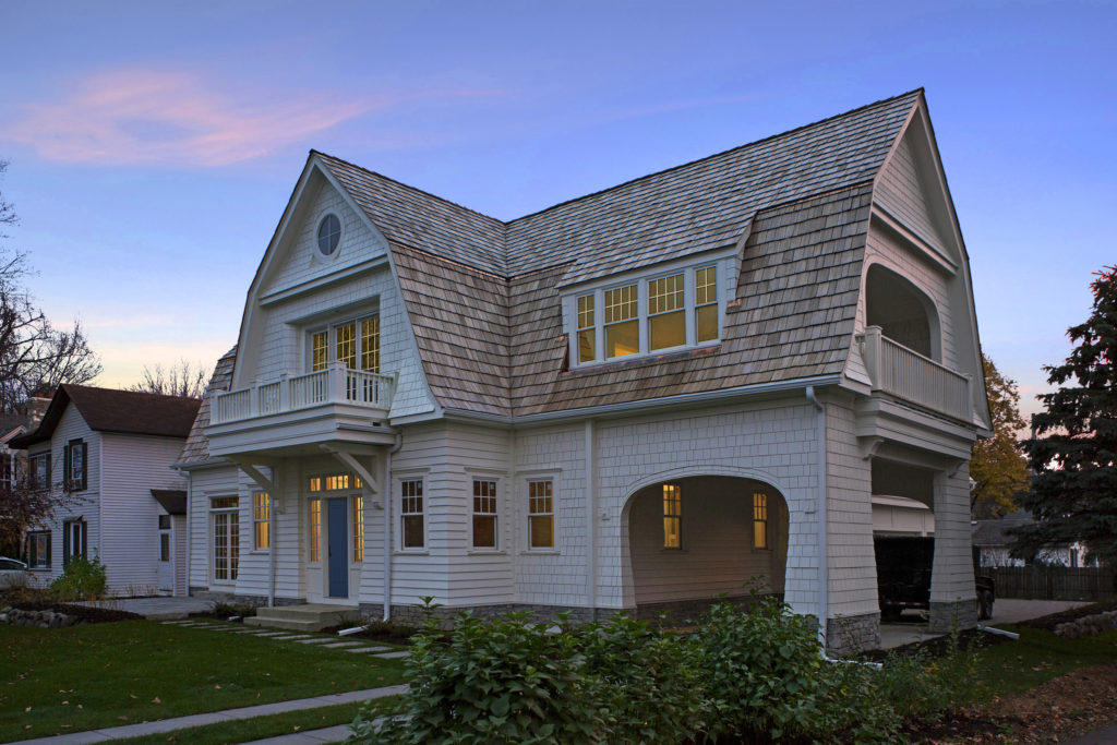 A large barn style home at sun down