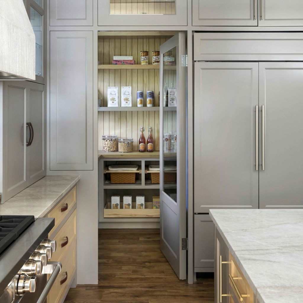A kitchen with marble stone countertops and white cupboards