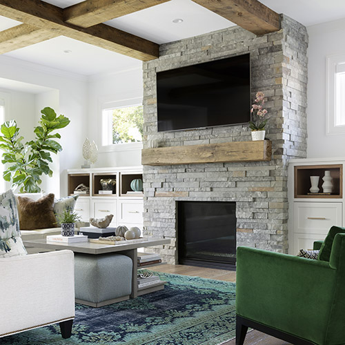 A home interior with a stone fireplace as the centerpiece of the living room