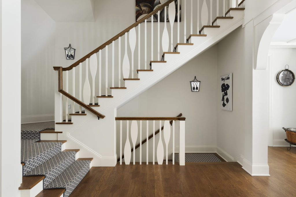 The staircase banister is detailed with paddles as another nod to the family's love of water.