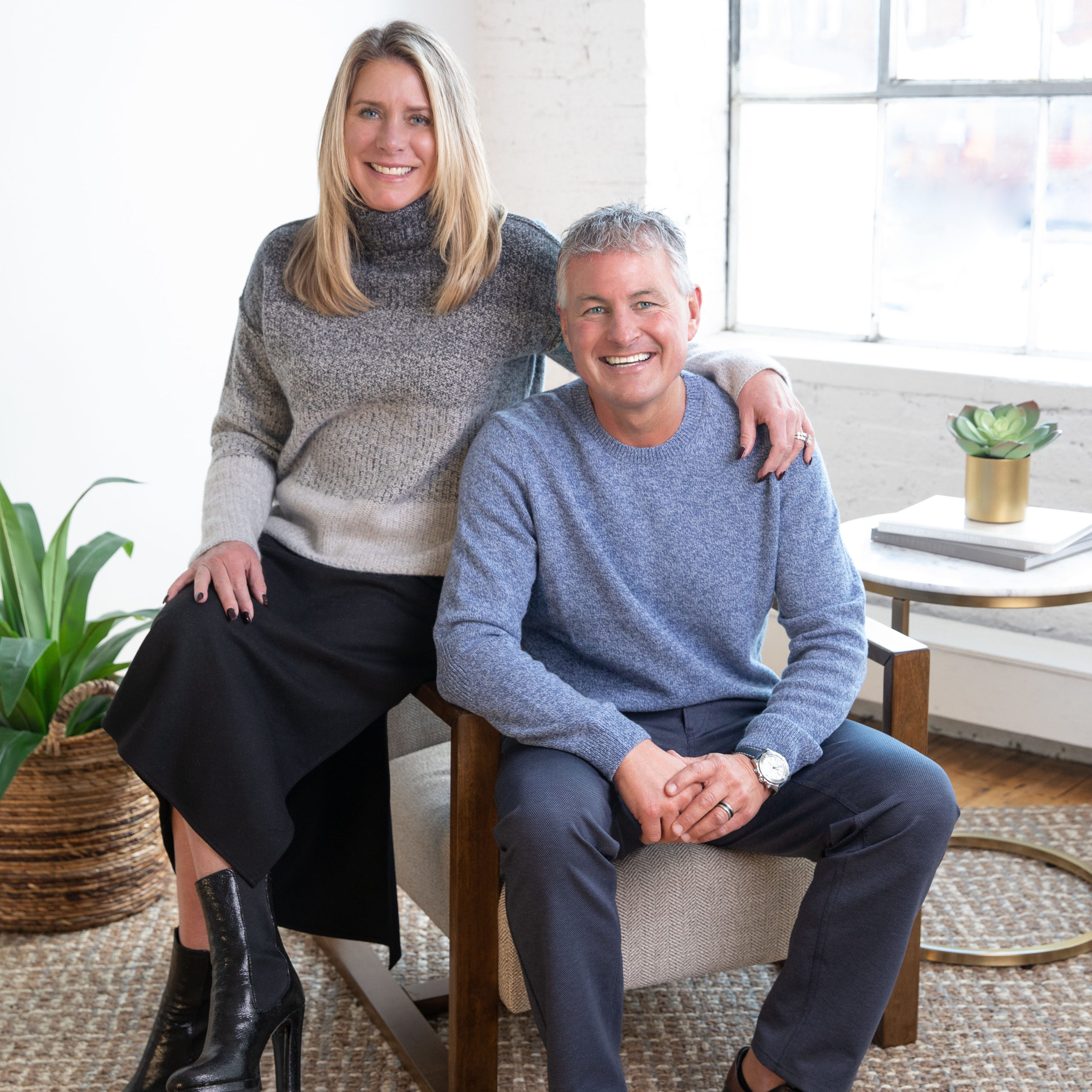 Todd and Pamela Simming sitting together on a chair while smiling